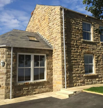 White uPVC sash windows on traditional home