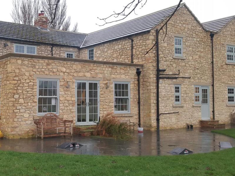 Grey uPVC sliding sash window installation